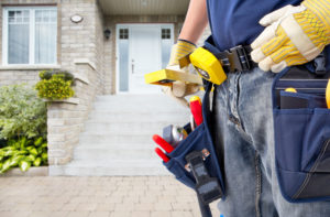 Handyman with a tool belt. House renovation service.